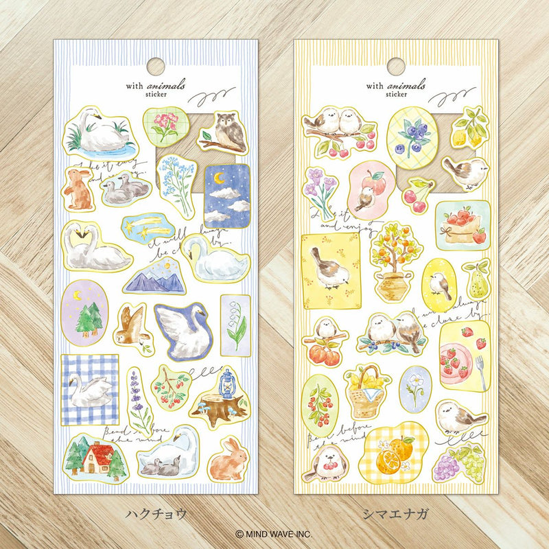 Two packages of decorative stickers with animal illustrations on a wooden surface.