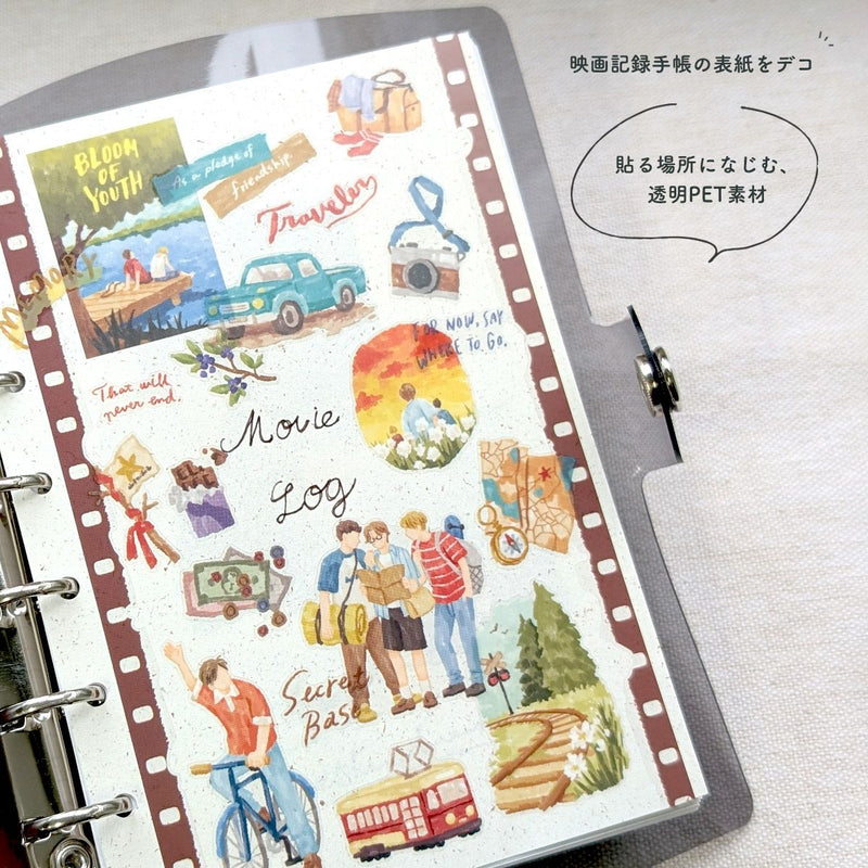 Sticker sheet with travel-themed designs on a ring-bound notebook.