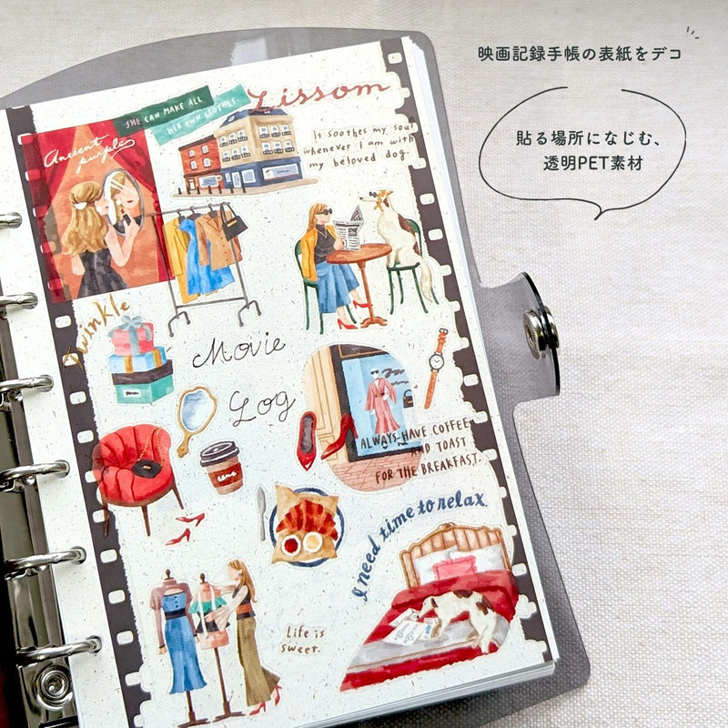 Planner with decorative stickers featuring various scenes and text on a white background.