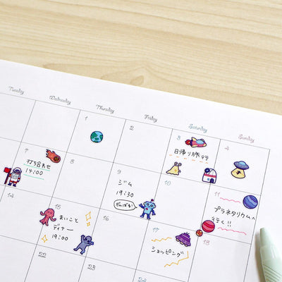 Calendar with cartoon illustrations on a wooden surface