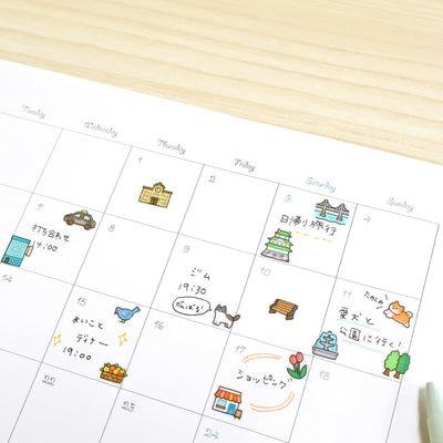 Calendar with illustrated events on a wooden surface