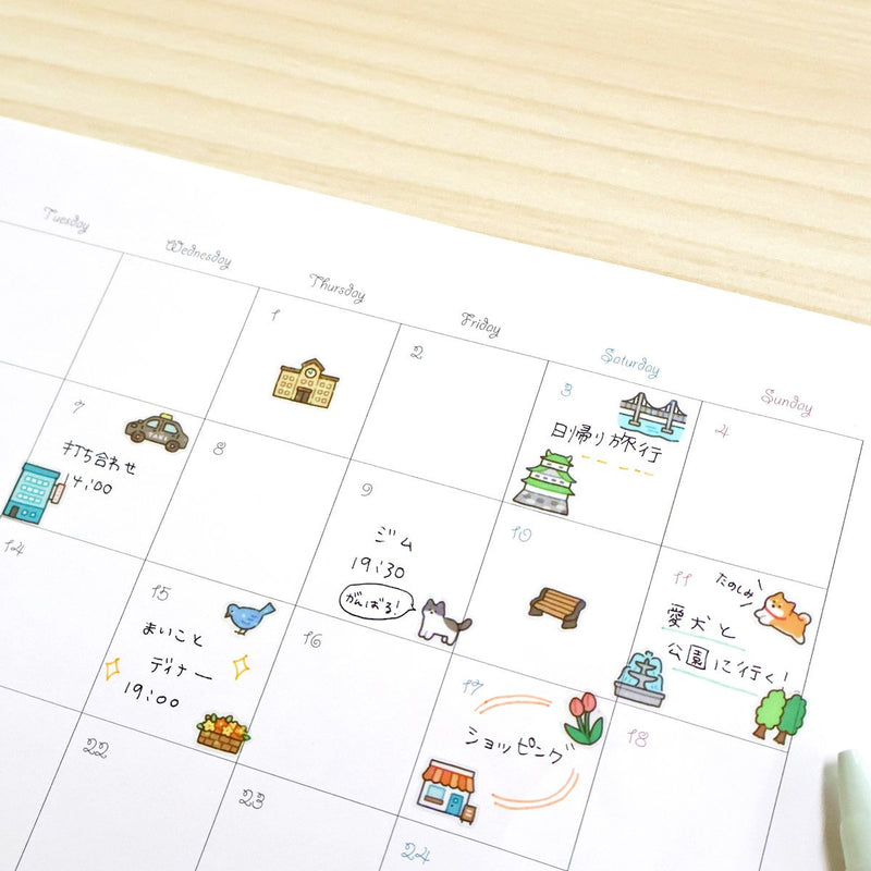 Calendar with illustrated events on a wooden surface