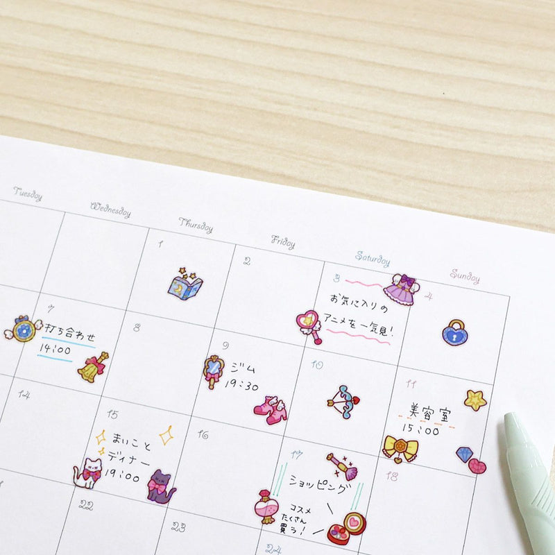 Calendar with cartoon character stickers on a wooden surface