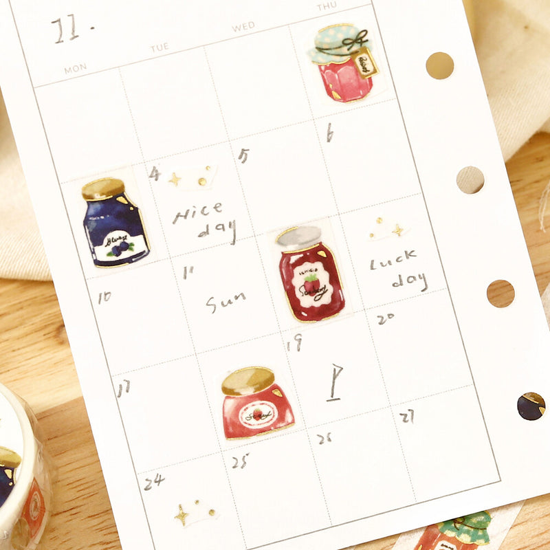 Calendar sheet with jam jar illustrations on a wooden surface