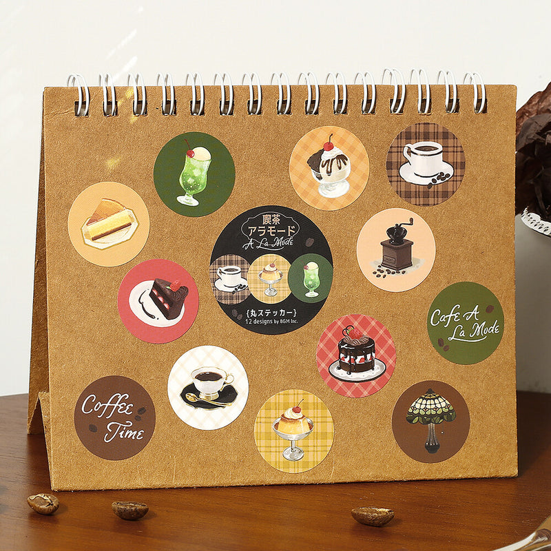 Calendar with coffee-themed stickers on a wooden surface