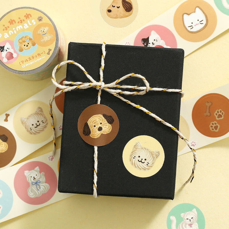Black gift box with decorative animal stickers on a yellow background