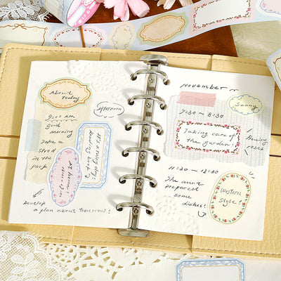 Planner with decorative stickers and handwritten notes on a lace tablecloth.