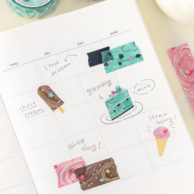 Calendar sheet with ice cream-themed stickers on a white surface
