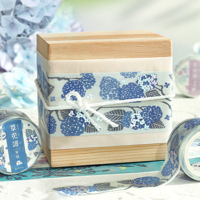 Wooden box wrapped with blue floral tape on a light background