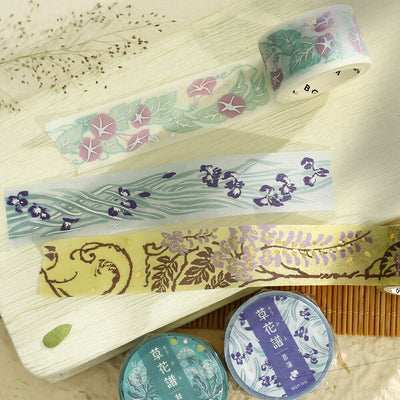 Set of decorative tapes with floral patterns on a wooden surface