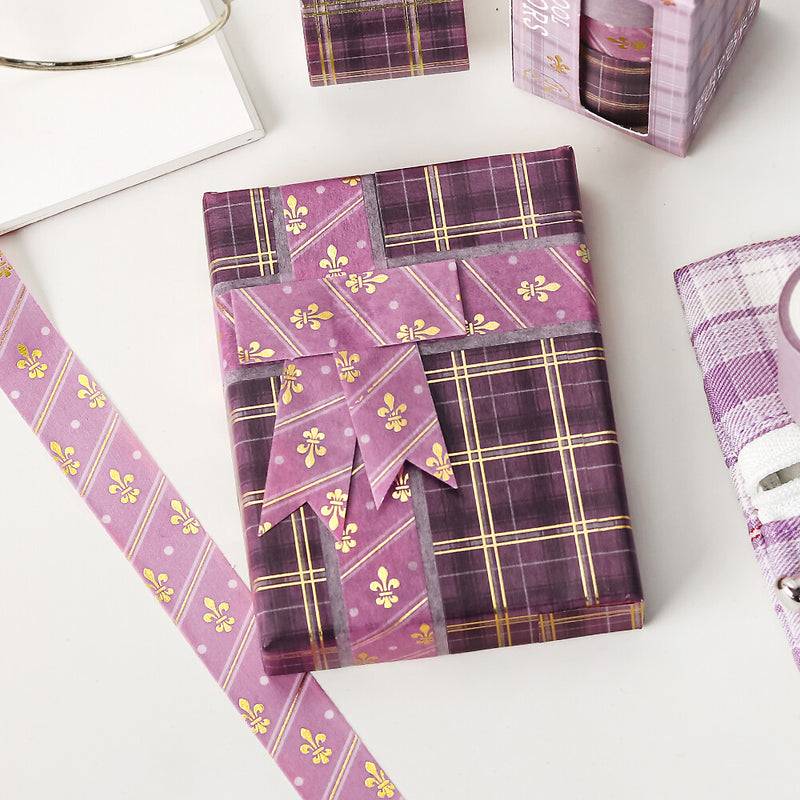 Purple plaid gift wrap with decorative patterns on a white surface