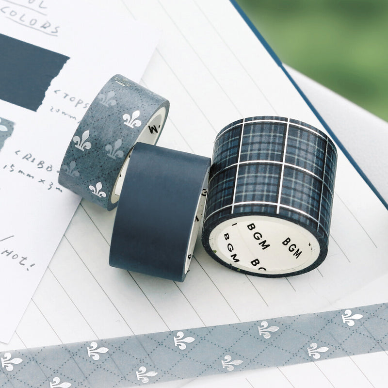 Three rolls of washi tape with different patterns on a white surface.