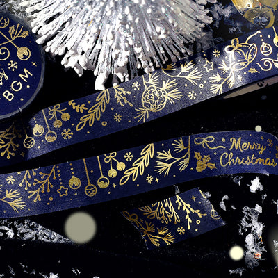 Decorative tape with gold Christmas designs on a dark background