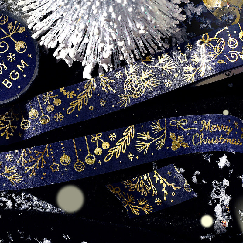 Decorative tape with gold Christmas designs on a dark background