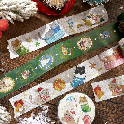 Decorative tape with festive cat illustrations on a wooden surface.
