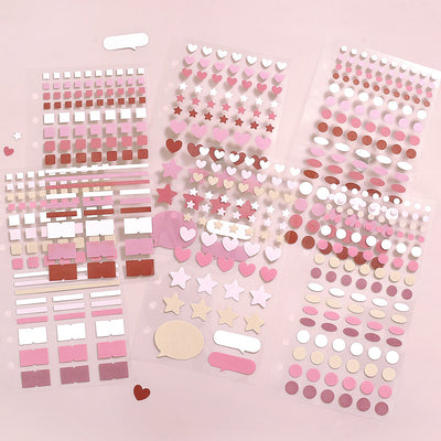 Collection of pink and white decorative stickers on a pink background
