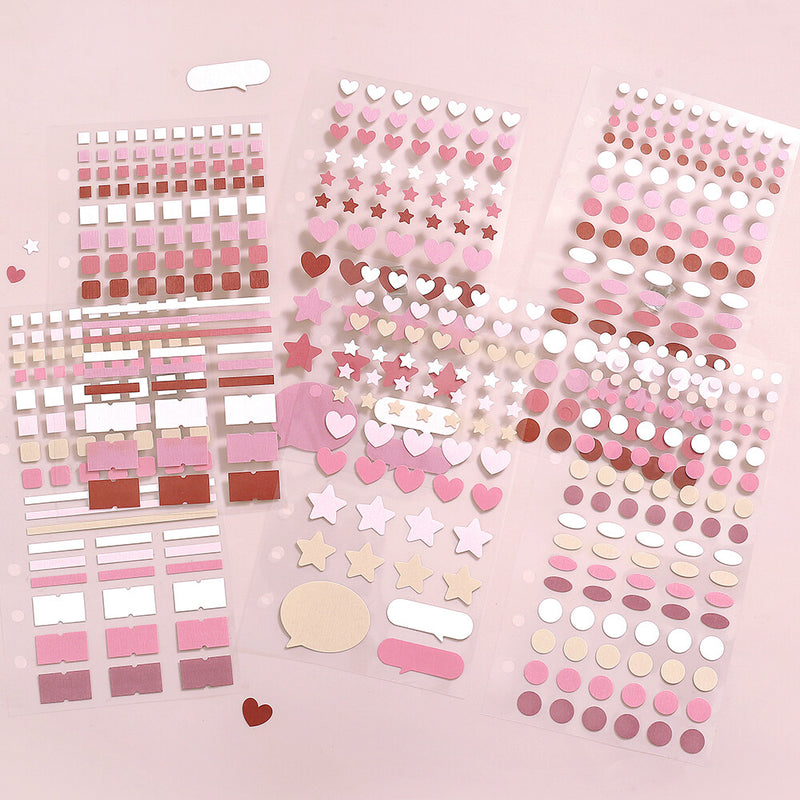 Collection of pink and white decorative stickers on a pink background