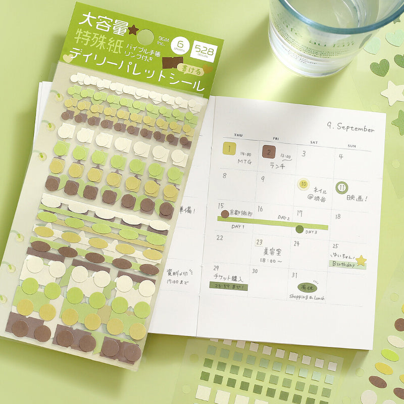 Packaging of decorative stickers with a calendar on a green surface