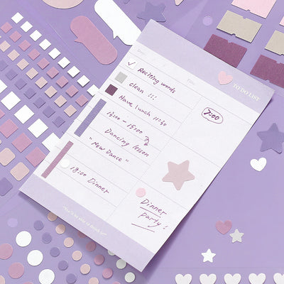 To-do list on a purple notepad with decorative stickers on a matching purple background