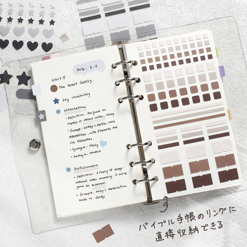 Open planner with notes and color swatches on a light gray background