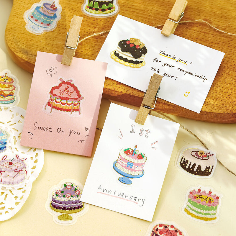 Stickers of cakes with messages on a wooden board