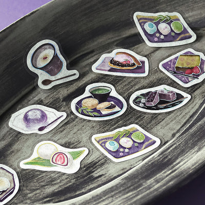 Stickers of Japanese sweets on a textured surface