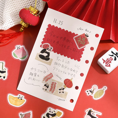Notebook with panda illustrations and stickers on a red background