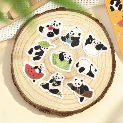 Set of panda-themed stickers on a wooden surface