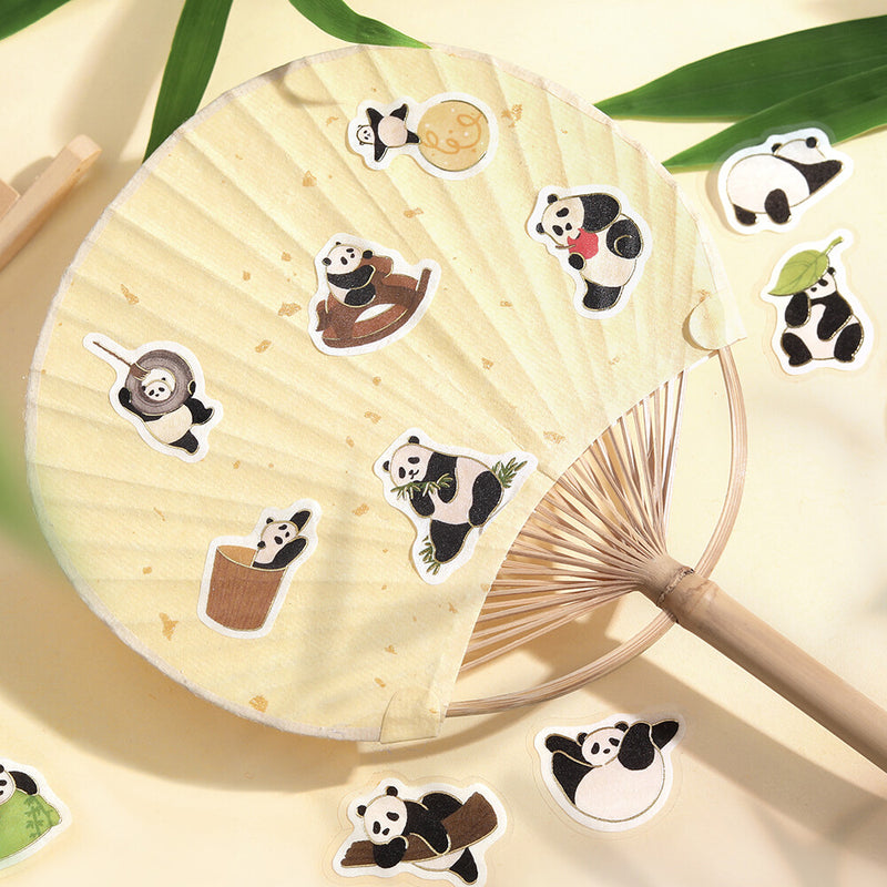 Decorative fan with panda stickers on a light background