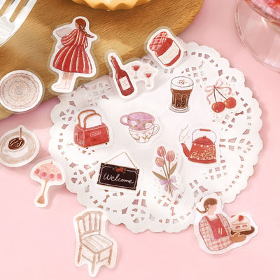 Set of decorative stickers on a pink surface with a doily