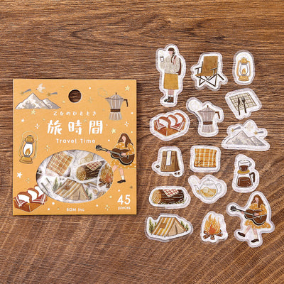Pack of travel-themed stickers with a wooden background