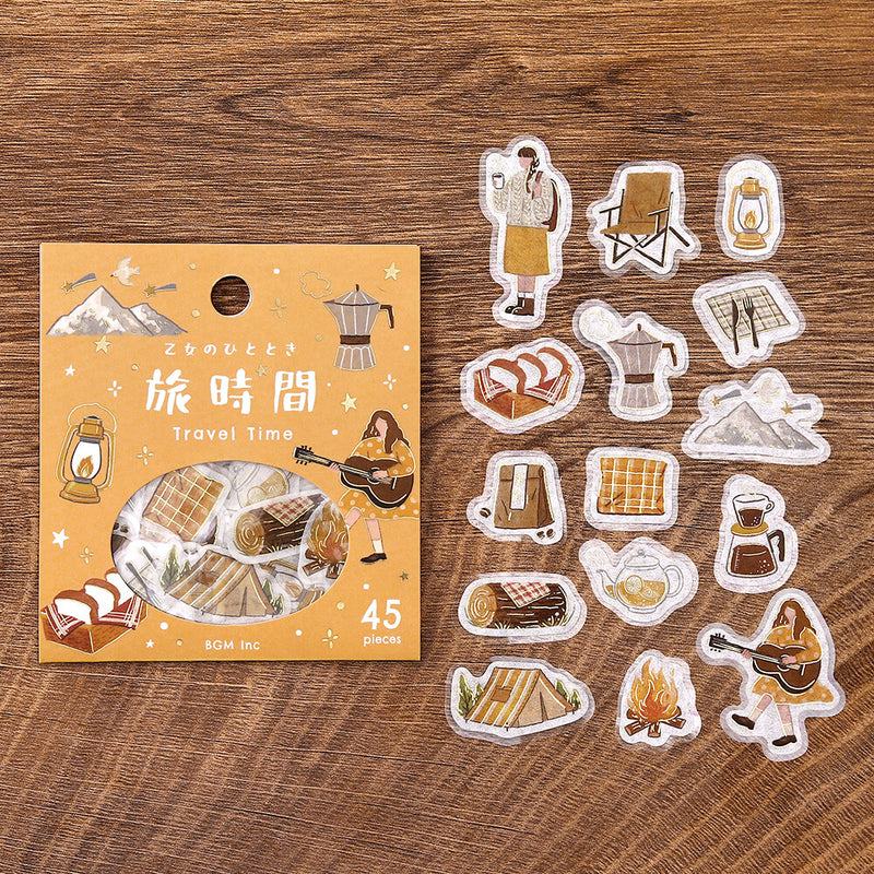 Pack of travel-themed stickers with a wooden background