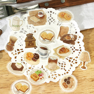 Set of illustrated coffee and pastries on a doily with a wooden surface.