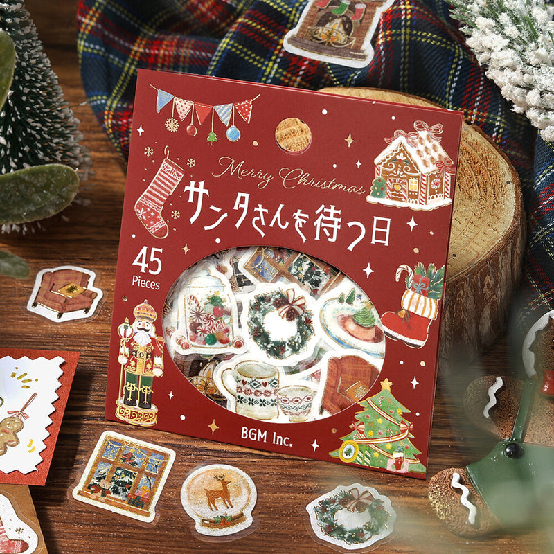 Pack of Christmas-themed stickers with decorative elements on a wooden surface.