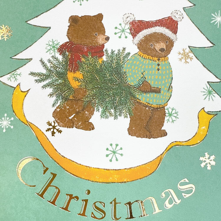 Two bears holding a Christmas tree with &