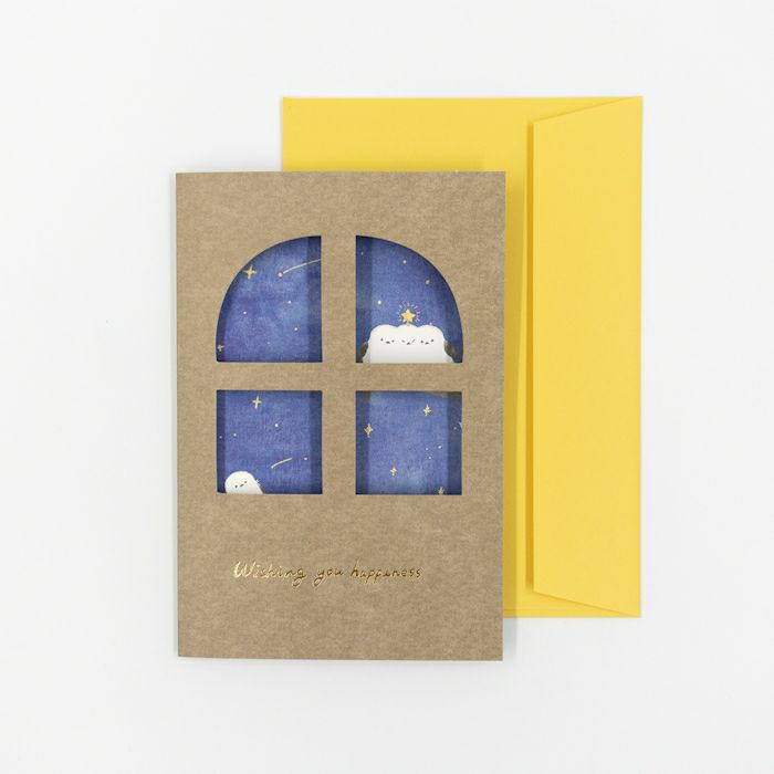 Greeting card with starry night design and yellow envelope on a white background