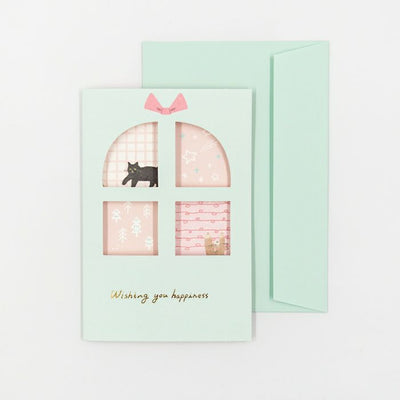 Greeting card with a cat illustration and 'Wishing you happiness' text on a light green background
