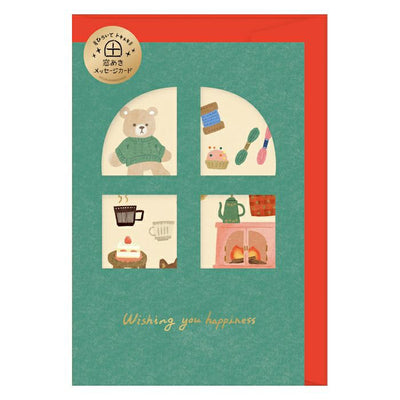 Greeting card with illustrations of a bear, cupcake, coffee, and fireplace on a green background with red border.