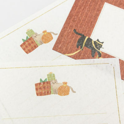 Set of stationery items with cat and plant designs on a white background