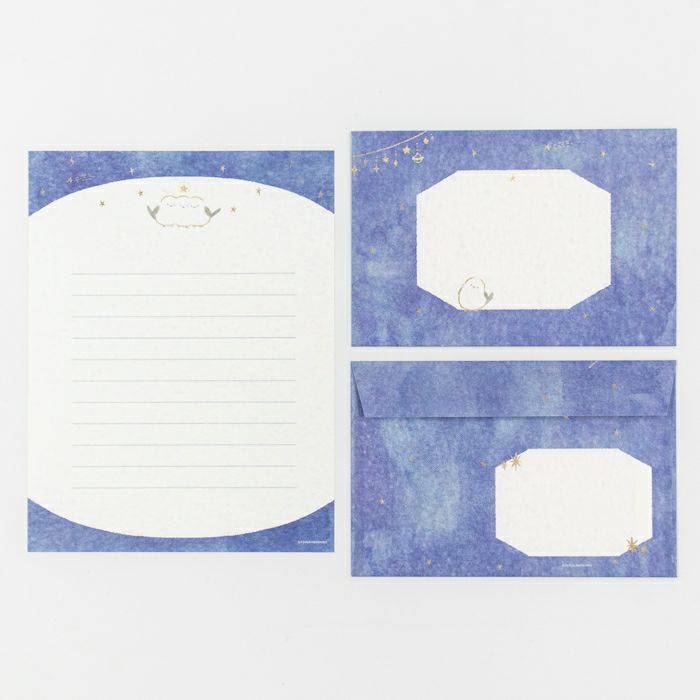 Set of stationery items with lined paper, envelopes, and labels on a blue textured background