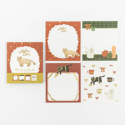 Set of stationery pads with cat-themed designs on a white background