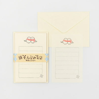 Stationery set with a letter and envelope featuring cartoon characters on a light gray background