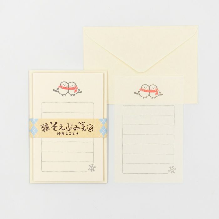 Stationery set with a letter and envelope featuring cartoon characters on a light gray background