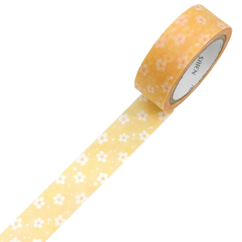 Roll of yellow tape with white floral pattern on a white background